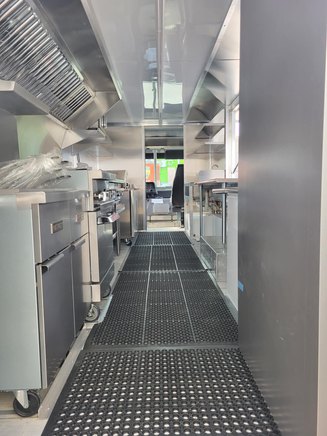 Different angle of food truck interior with flooring and mats
