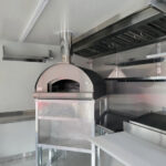 This food truck buildout includes a state-of-the-art pizza oven, ready to serve up mouthwatering slices on the go.